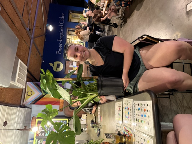A guest holding her new plant friend