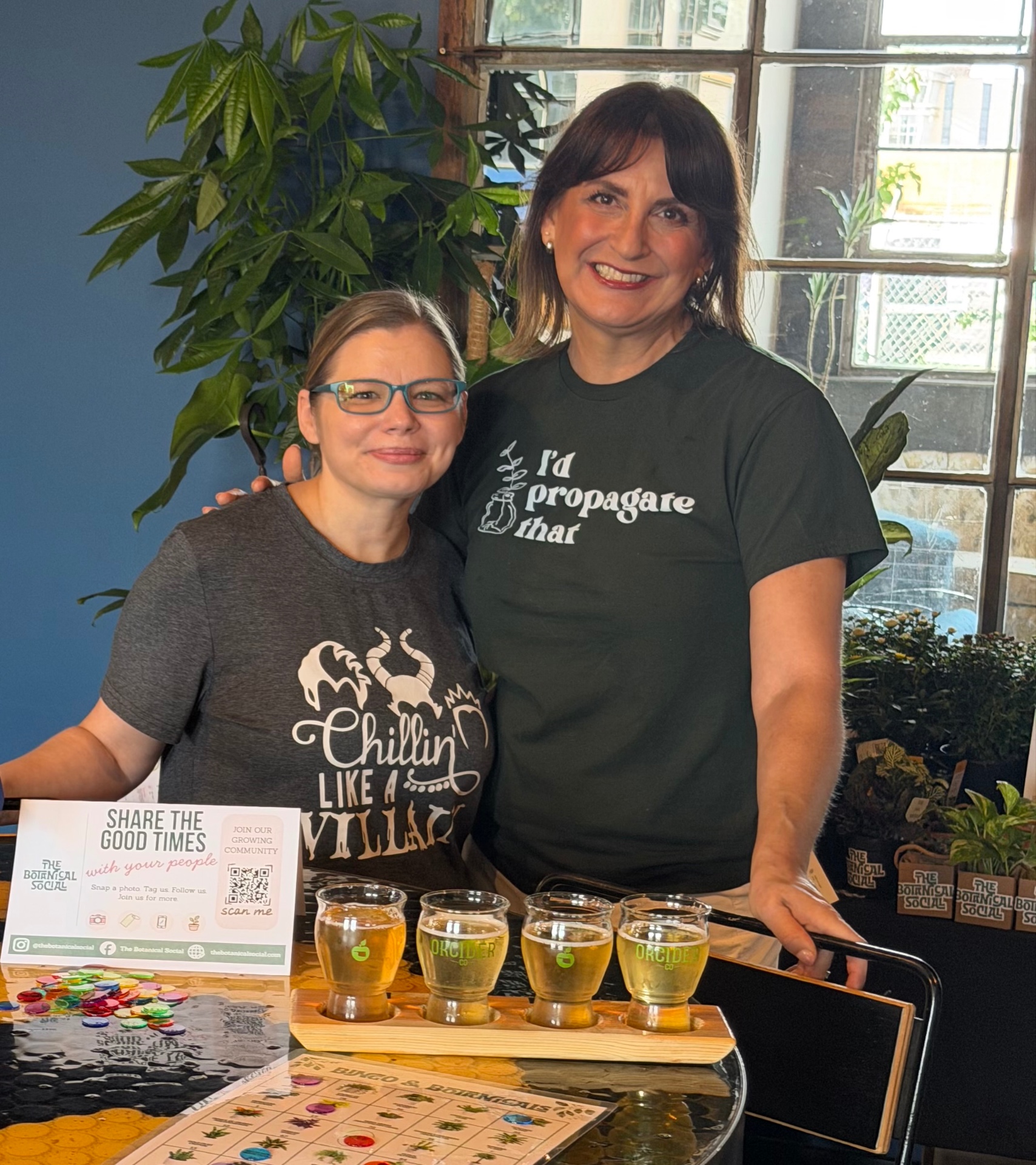 Two friends holding their new plants at a Botanical Social event